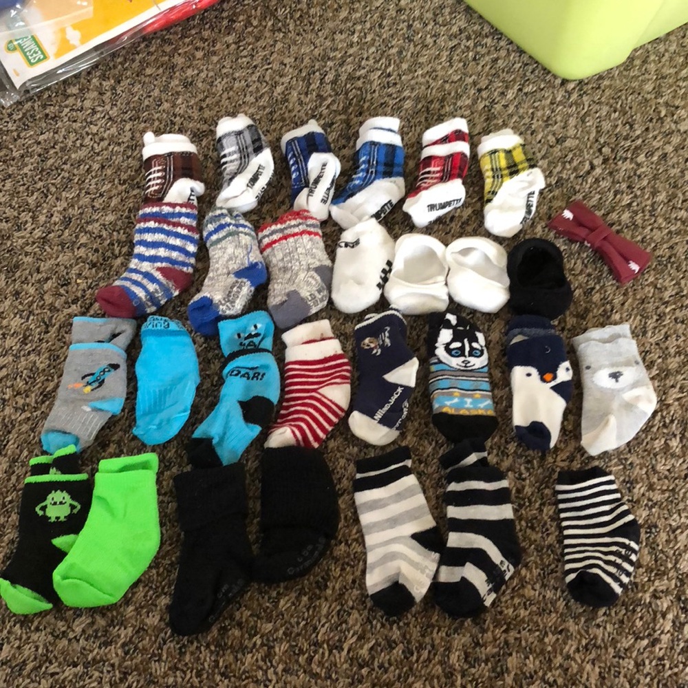 28 pairs of baby boy socks & a button on bow tie